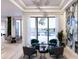 Bright living room with modern chandelier, stylish seating, and decorative stone feature wall with water view at 1384 Harbor Dr, Sarasota, FL 34239