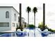 A luxurious in-ground pool with built-in lounge chairs, palm trees, and an upper level dining area at 1384 Harbor Dr, Sarasota, FL 34239