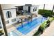 Aerial view of the sparkling pool featuring sun loungers and an adjacent outdoor dining area on the upper level at 1384 Harbor Dr, Sarasota, FL 34239