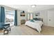 Well-lit bedroom featuring a comfortable bed, TV, and access to the patio at 170 Roosevelt Dr # 2, Sarasota, FL 34236