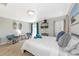 Bright bedroom featuring a comfortable bed, TV, and surf-themed decor at 170 Roosevelt Dr # 2, Sarasota, FL 34236