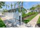 Beautiful exterior view of the home with a white fence and manicured landscaping at 170 Roosevelt Dr # 2, Sarasota, FL 34236