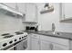 Charming kitchenette with light cabinets, subway tile backsplash, and modern appliances for efficient cooking at 170 Roosevelt Dr # 2, Sarasota, FL 34236