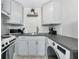 Efficient kitchenette features light gray cabinets, dark counters, modern appliances, and ample storage space at 170 Roosevelt Dr # 2, Sarasota, FL 34236