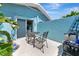 Cozy patio with an outdoor dining set and lush greenery for privacy at 170 Roosevelt Dr # 2, Sarasota, FL 34236