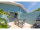 Relaxing patio with a table, chairs, and a peaceful backyard view at 170 Roosevelt Dr # 2, Sarasota, FL 34236