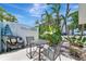 Outdoor patio area with table, chairs, and tropical plants for relaxing at 170 Roosevelt Dr # 2, Sarasota, FL 34236