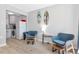 Cozy sitting area features two armchairs, surfboard decor, and kitchenette with white appliances at 170 Roosevelt Dr # 2, Sarasota, FL 34236