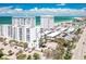 Aerial view of the condo complex near the beach with parking and palm trees at 1770 Benjamin Franklin Dr # 407, Sarasota, FL 34236