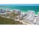 Panoramic aerial view of beachfront condos with sparkling turquoise waters and lush landscaping at 1770 Benjamin Franklin Dr # 407, Sarasota, FL 34236