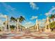The bayfront entrance offers a picturesque view with architectural elements, palm trees, and bay access at 1770 Benjamin Franklin Dr # 407, Sarasota, FL 34236