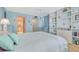 Airy bedroom with soft colors, a built-in bookshelf, and an ensuite bathroom and ample natural light at 1770 Benjamin Franklin Dr # 407, Sarasota, FL 34236