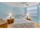 Bedroom featuring light blue walls, matching nightstands and flamingo bedding at 1770 Benjamin Franklin Dr # 407, Sarasota, FL 34236