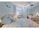 Bright bedroom features a large window, ceiling fan and mirrored closet at 1770 Benjamin Franklin Dr # 407, Sarasota, FL 34236