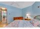 Bedroom with view to hall, light blue walls and flamingo bedding at 1770 Benjamin Franklin Dr # 407, Sarasota, FL 34236