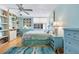 Serene bedroom with built-in bookshelves and storage, ceiling fan and soft natural light at 1770 Benjamin Franklin Dr # 407, Sarasota, FL 34236