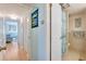 Hallway leading to a bedroom and bathroom, with closet storage, creating a sense of flow and functionality at 1770 Benjamin Franklin Dr # 407, Sarasota, FL 34236