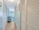 Hallway featuring multiple closet spaces for storage and organization with views of the bedroom at 1770 Benjamin Franklin Dr # 407, Sarasota, FL 34236