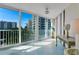 Enclosed lanai with floor-to-ceiling windows offering beautiful views of the lush landscaping and neighborhood at 1770 Benjamin Franklin Dr # 407, Sarasota, FL 34236