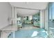 Bright living space featuring tile floors, coastal decor, large windows and access to the balcony at 1770 Benjamin Franklin Dr # 407, Sarasota, FL 34236