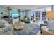 Bright living room with built-in shelves and ocean views from the large sliding glass doors at 1770 Benjamin Franklin Dr # 407, Sarasota, FL 34236