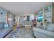 Bright living room with a blue coastal theme, comfortable seating, and built-in shelving for a relaxed atmosphere at 1770 Benjamin Franklin Dr # 407, Sarasota, FL 34236