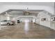 Bright parking garage with concrete floor and white support beams and some parked cars at 1770 Benjamin Franklin Dr # 407, Sarasota, FL 34236