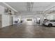 Bright parking garage with concrete floor and white support beams and some parked cars at 1770 Benjamin Franklin Dr # 407, Sarasota, FL 34236