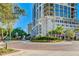 Beautiful street view of Insula Buchanan with landscaped roundabout and lush greenery, showcasing a luxurious urban setting at 1770 Benjamin Franklin Dr # 407, Sarasota, FL 34236