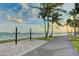 Scenic waterfront path featuring palm trees, water views, bike racks and benches along the walkway at 1770 Benjamin Franklin Dr # 407, Sarasota, FL 34236