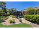 Beautiful backyard featuring a screened pool, lush landscaping, and manicured lawn for outdoor enjoyment at 1780 Pine Harrier Cir, Sarasota, FL 34231