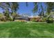 Expansive backyard showcases a well-maintained lawn, mature trees, and a screened pool, perfect for outdoor activities at 1780 Pine Harrier Cir, Sarasota, FL 34231