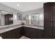 Well-lit bathroom with a double sink vanity, stone countertops, and modern cabinetry at 1780 Pine Harrier Cir, Sarasota, FL 34231