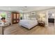 Serene bedroom featuring a plush bed, ample natural light, and a view into the ensuite bathroom at 1780 Pine Harrier Cir, Sarasota, FL 34231