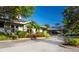 Community entrance with well-maintained landscaping, mature trees, and a covered portico, creating an inviting arrival experience at 1780 Pine Harrier Cir, Sarasota, FL 34231