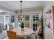 Cozy dining area with a round table and chairs, adjacent to sliding glass doors providing views of the pool at 1780 Pine Harrier Cir, Sarasota, FL 34231