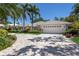 Lovely home with a paver driveway, well-manicured landscaping, palm trees, and a spacious two-car garage at 1780 Pine Harrier Cir, Sarasota, FL 34231