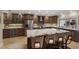 Gourmet kitchen with custom cabinets, stainless steel appliances, and a large island with seating for casual dining at 1780 Pine Harrier Cir, Sarasota, FL 34231
