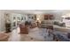 Spacious living room featuring tile floors, a large sofa, two armchairs, and glass doors to a lanai at 1780 Pine Harrier Cir, Sarasota, FL 34231
