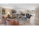 Bright living room featuring neutral furniture, decorative artwork, and an open floor plan leading to the dining area at 1780 Pine Harrier Cir, Sarasota, FL 34231