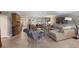 Open-concept living room boasts tile flooring, neutral tones, and lots of seating for entertaining at 1780 Pine Harrier Cir, Sarasota, FL 34231
