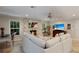 Cozy living room featuring a stone fireplace, a comfortable white sofa, and natural light from the surrounding windows at 1780 Pine Harrier Cir, Sarasota, FL 34231