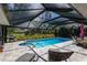 Inviting screened pool area with lounge chairs and dining set, perfect for relaxation and outdoor enjoyment at 1780 Pine Harrier Cir, Sarasota, FL 34231