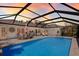 Expansive screened-in pool area with outdoor dining and lounge seating, creating a perfect backyard oasis at 1780 Pine Harrier Cir, Sarasota, FL 34231