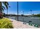 Community tennis courts with benches, lighting, and landscaping, offering a great outdoor recreational space at 1780 Pine Harrier Cir, Sarasota, FL 34231