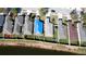 Aerial view of single Gathering home with pond view and a blue tarp on the roof at 2330 28Th E Ave, Palmetto, FL 34221