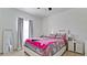 Bedroom with a window with curtains, a decorative bed set, and a nightstand with a lamp at 2330 28Th E Ave, Palmetto, FL 34221