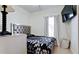Bedroom features a mirrored headboard, comfortable bed, bright window and a modern television at 2330 28Th E Ave, Palmetto, FL 34221