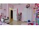 Pink bedroom with tile floor, closet and adjacent bathroom at 2330 28Th E Ave, Palmetto, FL 34221