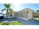 Charming single-story home featuring stucco siding, a one-car garage, a well-maintained lawn and mature landscaping at 2330 28Th E Ave, Palmetto, FL 34221